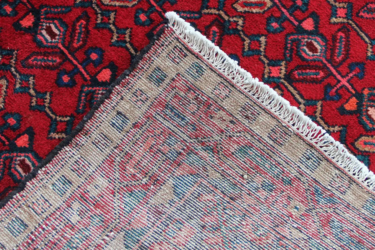 Hamadan runner hem view: braided edge with fringe at the end of the rug