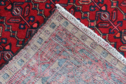 Hamadan runner hem view: braided edge with fringe at the end of the rug