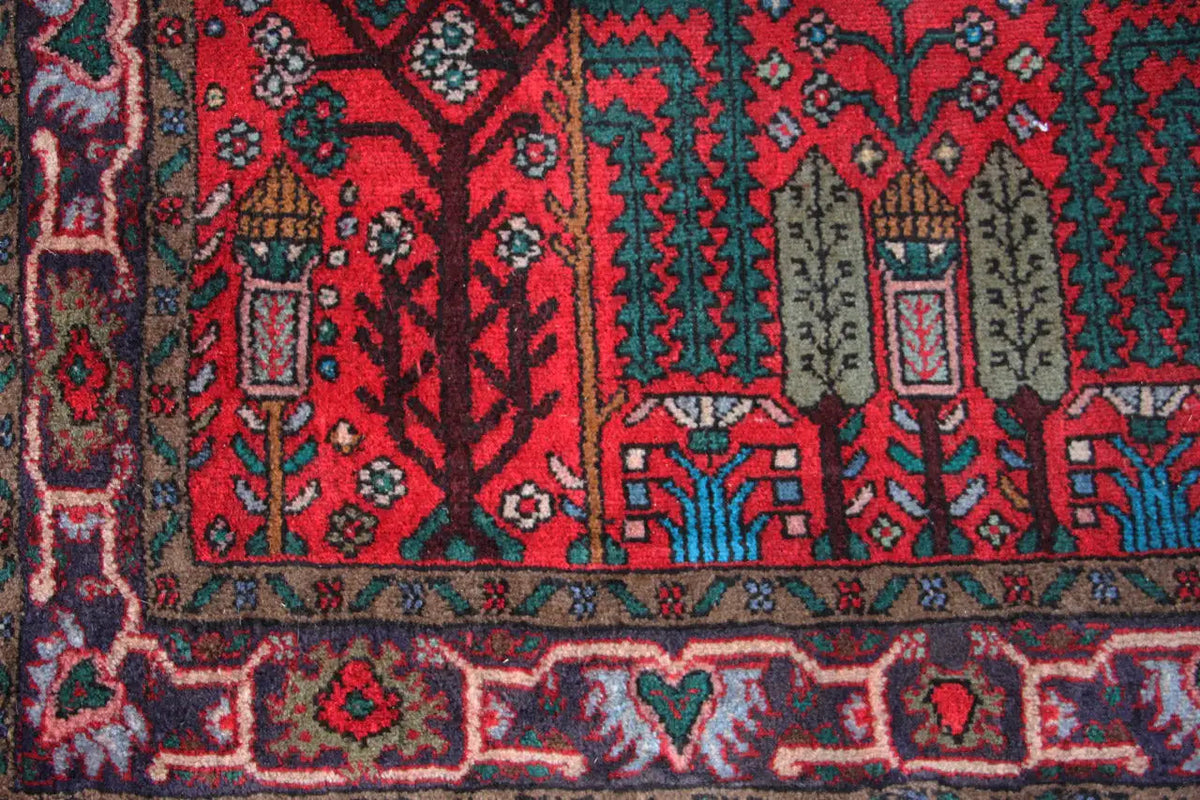 Hamadan runner detail view: red pattern with turquoise, green, and beige accents in rows.