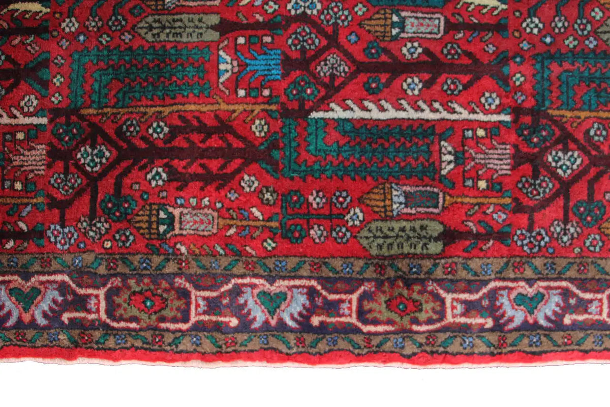 Hamadan runner detail: patterned stripes with small motifs, border visible along the lower edge.