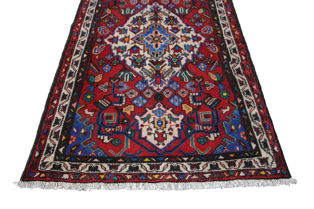 Hamadan rug: triangular-looking design with a large blue and red medallion