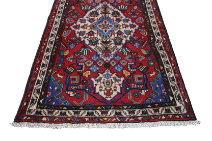 Hamadan rug: triangular-looking design with a large blue and red medallion