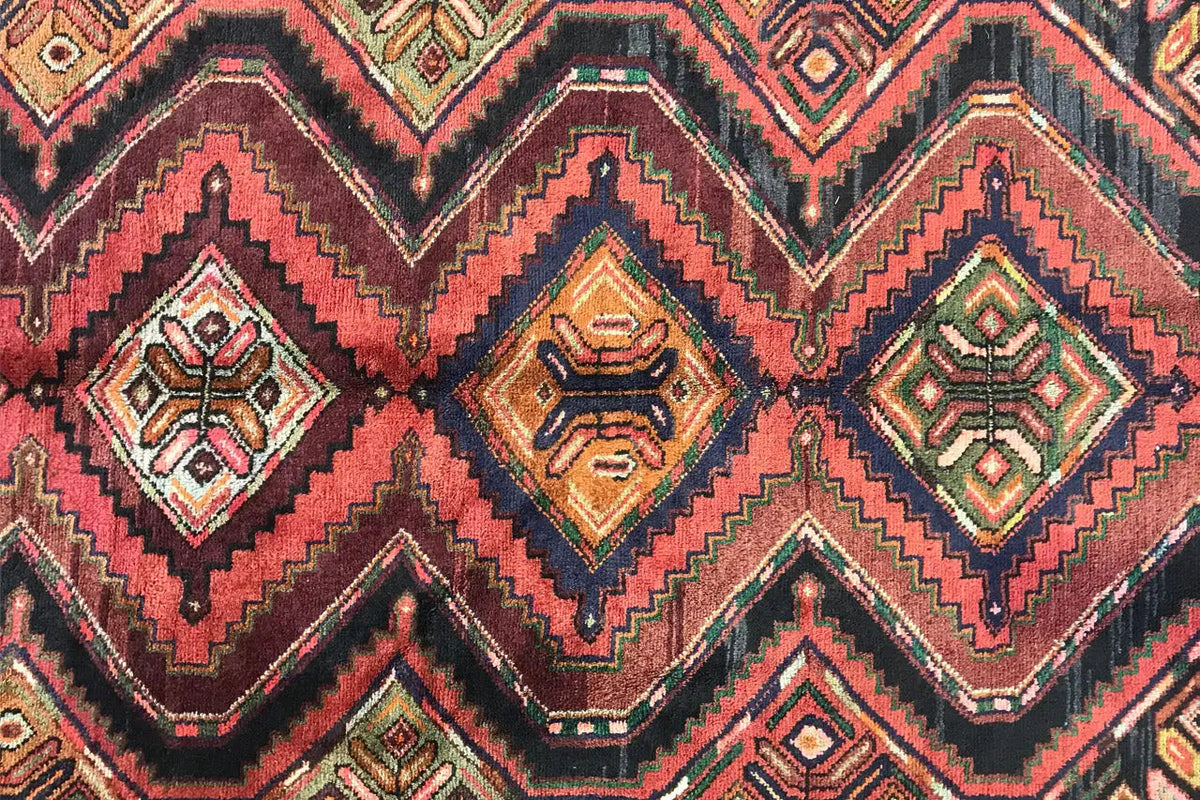 Close-up of the oriental runner rug with diamond and zigzag patterns, colorful