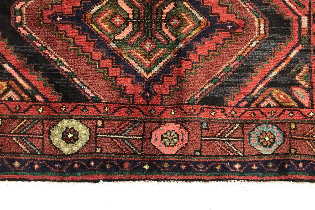 Edge view of the oriental rug runner with decorative border and round medallions, multicolored