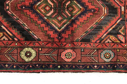 Edge view of the oriental rug runner with decorative border and round medallions, multicolored