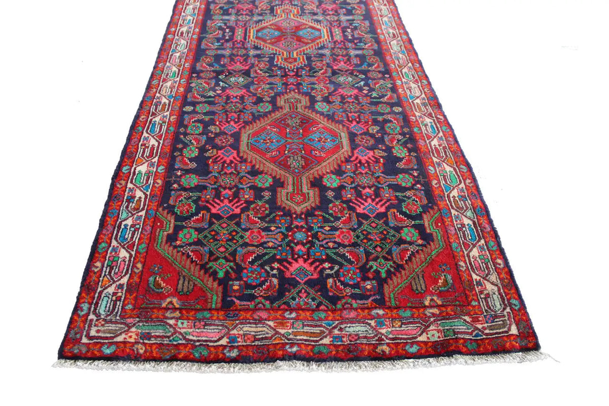 Oriental runner rug with a central medallion and colorful borders, with short fringes