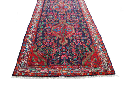 Oriental runner rug with a central medallion and colorful borders, with short fringes