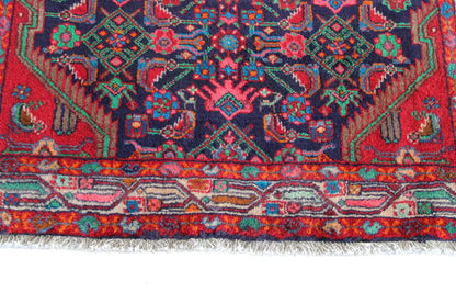 Close-up: woven rug edge with a border in red, blue, and turquoise