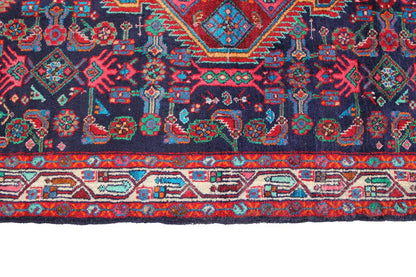 Detailed view of the lower border with decorative bands in red, blue, green and beige