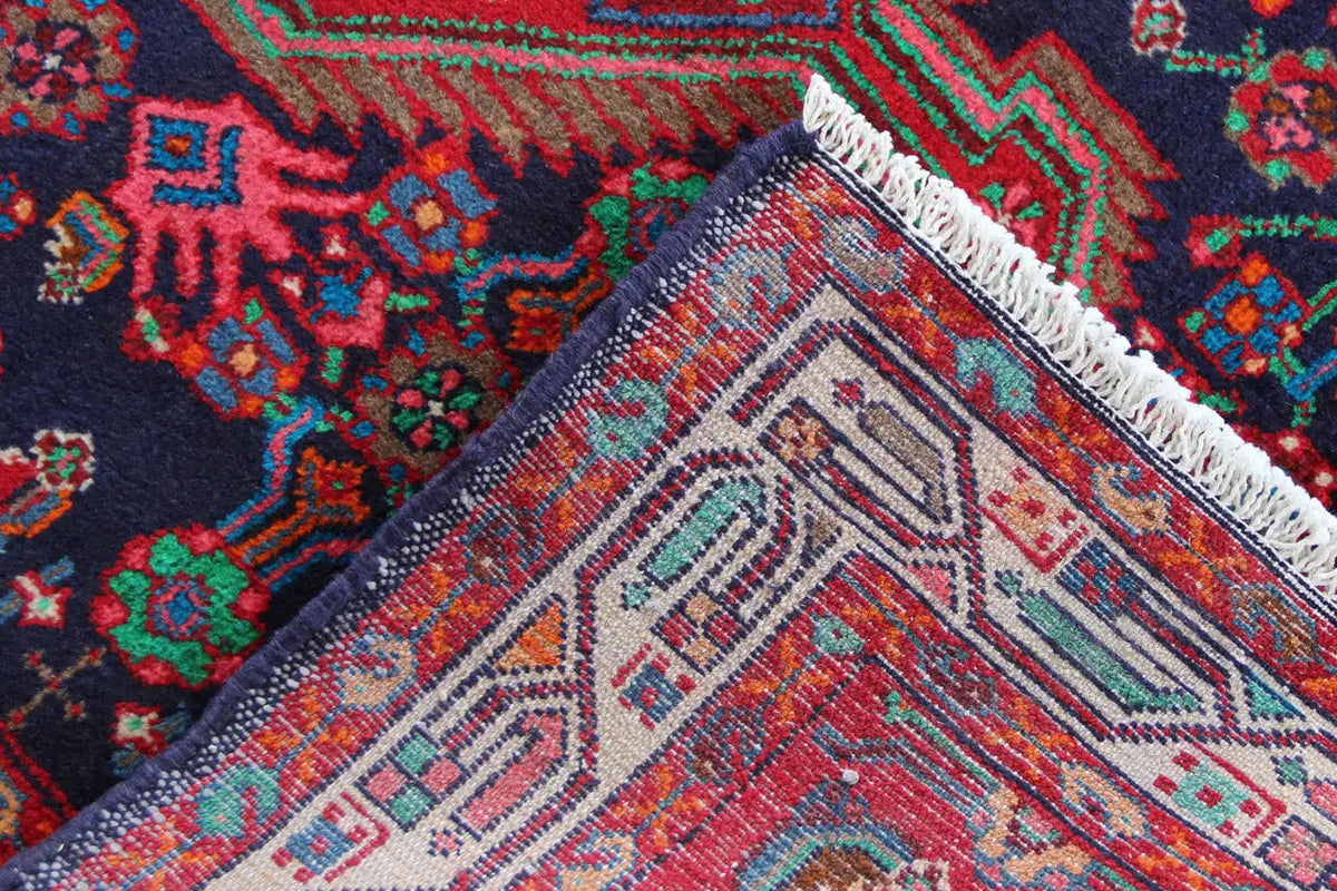 Corner with fringe and patterned section in blue, red, green, and beige
