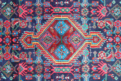 Rug pattern with a central diamond and many blue and red ornaments