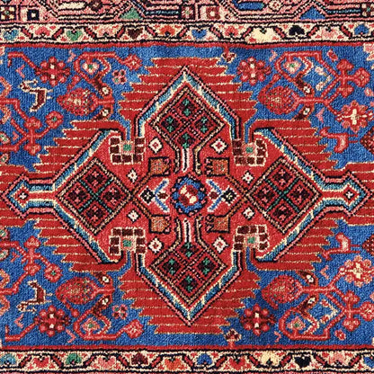 Hamadan carpet (132x80 cm) close-up: central diamond ornament in blue, red, and green