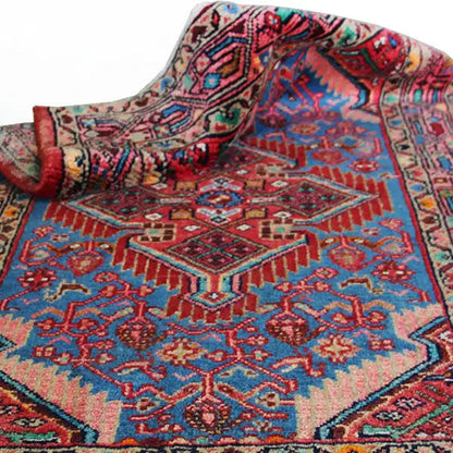 Hamadan carpet (132x80 cm) with a rolled-up corner, blue field and red ornament