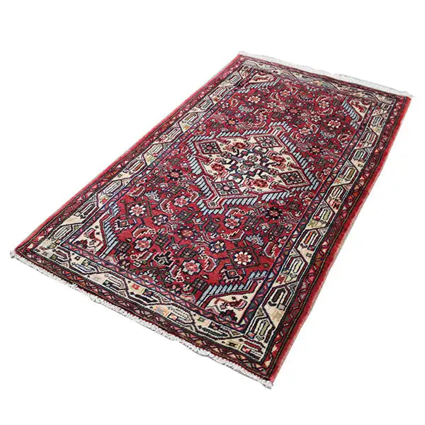 Hamadan rug with a red background, geometric pattern, and surrounding border
