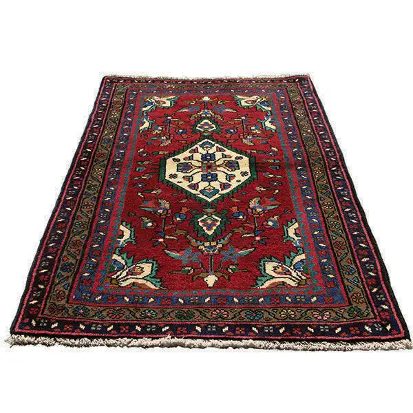 Oriental rug in burgundy with a large central medallion and surrounding border