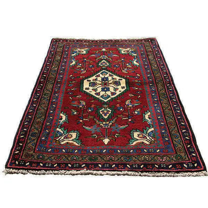 Oriental rug in burgundy with a large central medallion and surrounding border