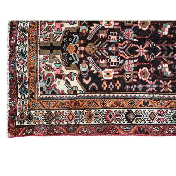 Oriental rug runner with a hemmed edge, blue-gray medallion, and colorful patterned bands
