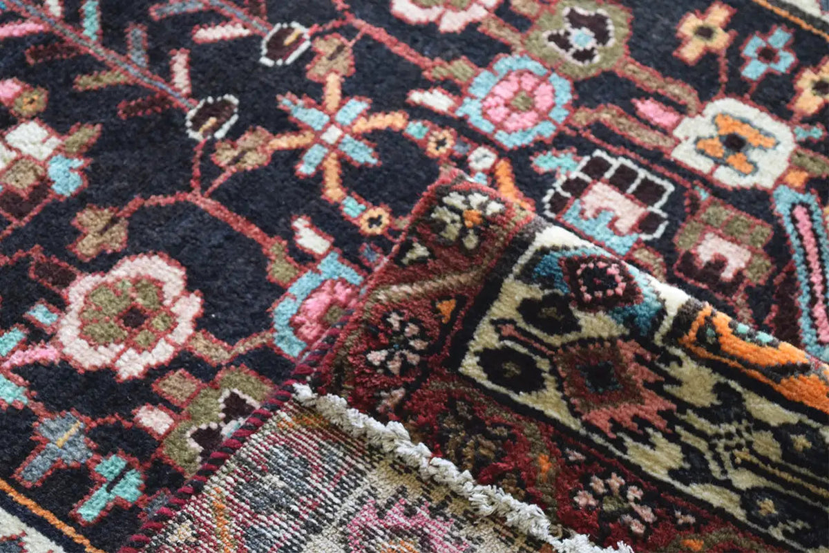 Oriental rug runner close-up: dense pile with colorful ornaments and geometric motifs
