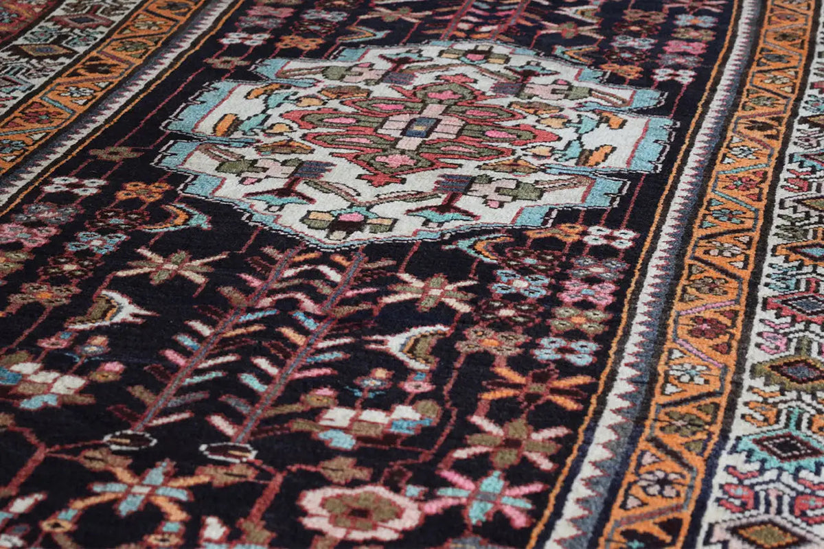 Oriental rug runner detail with central patterns and multicolored border bands