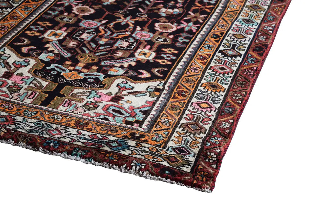 Oriental rug runner with a wide border and multicolored pattern, visible edge finishing
