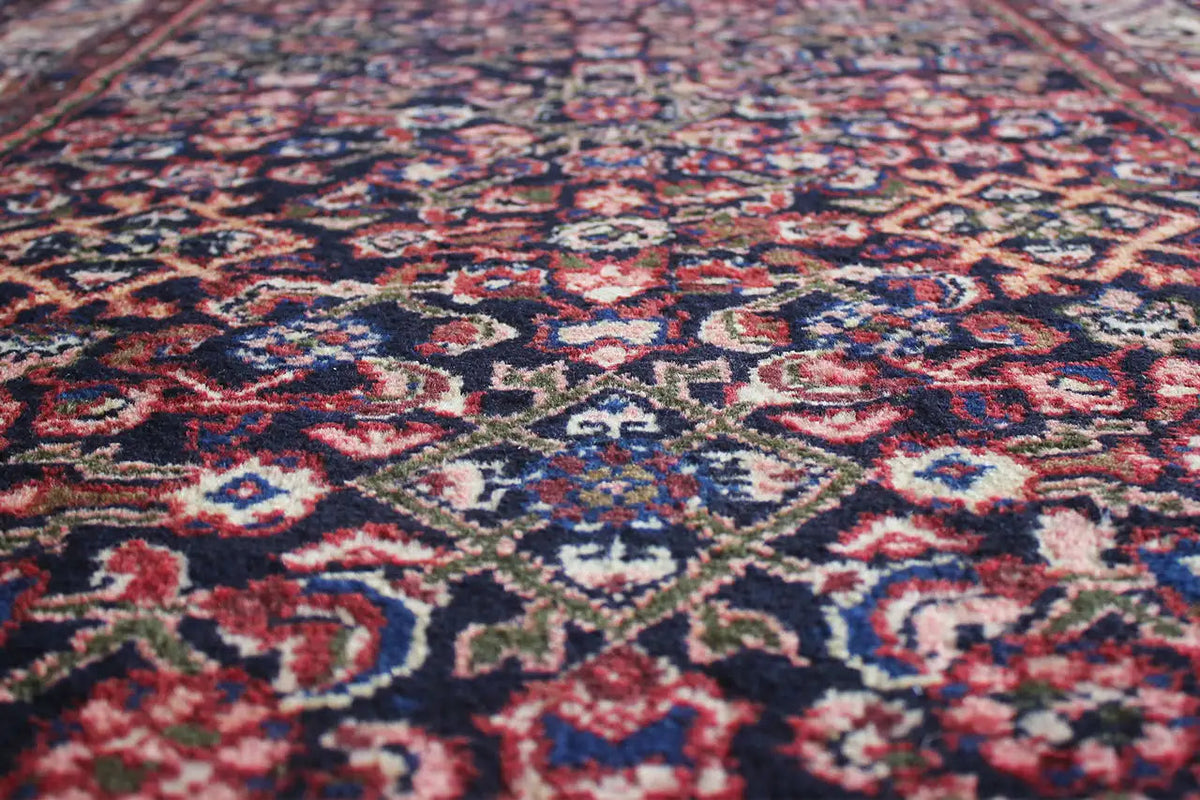 Runner detail with finely patterned ornaments in blue, red and beige on a dark background