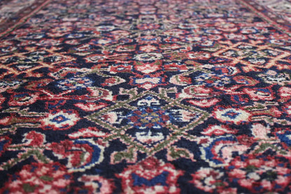 Runner detail with finely patterned ornaments in blue, red and beige on a dark background
