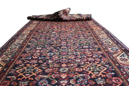 Runner with a large central motif and decorative borders in shades of red, blue, and beige