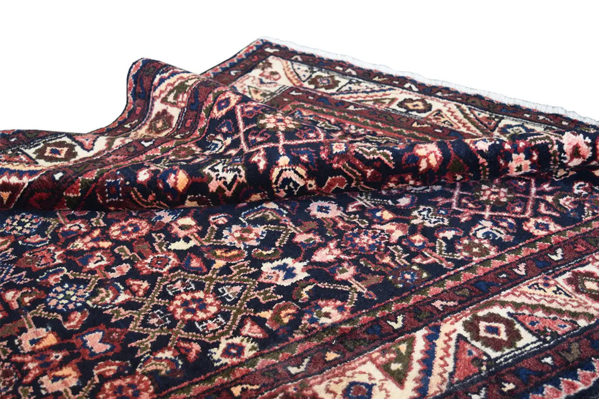 Rolled-up runner: lively ornamental pattern and decorative trim in blue, red, and beige