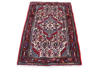 Hamadan rug with a red background and blue-and-white geometric patterns, rectangular