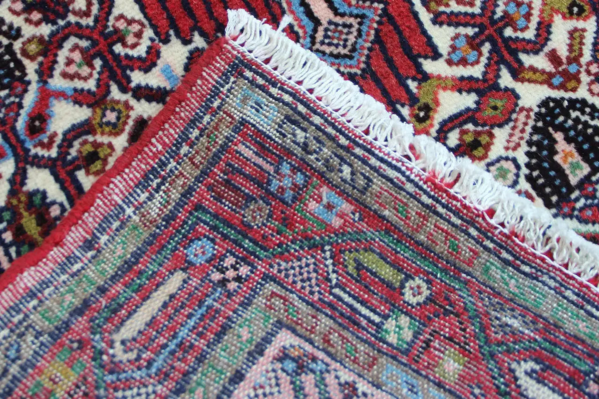 Close-up of the weave structure and fringes of a Hamadan rug, blue-green pattern