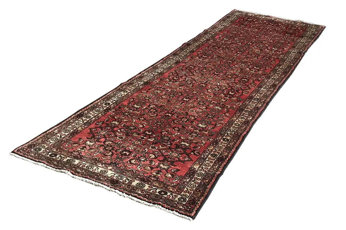 Rectangular runner rug, reddish-brown with a dark pile and ornamental border