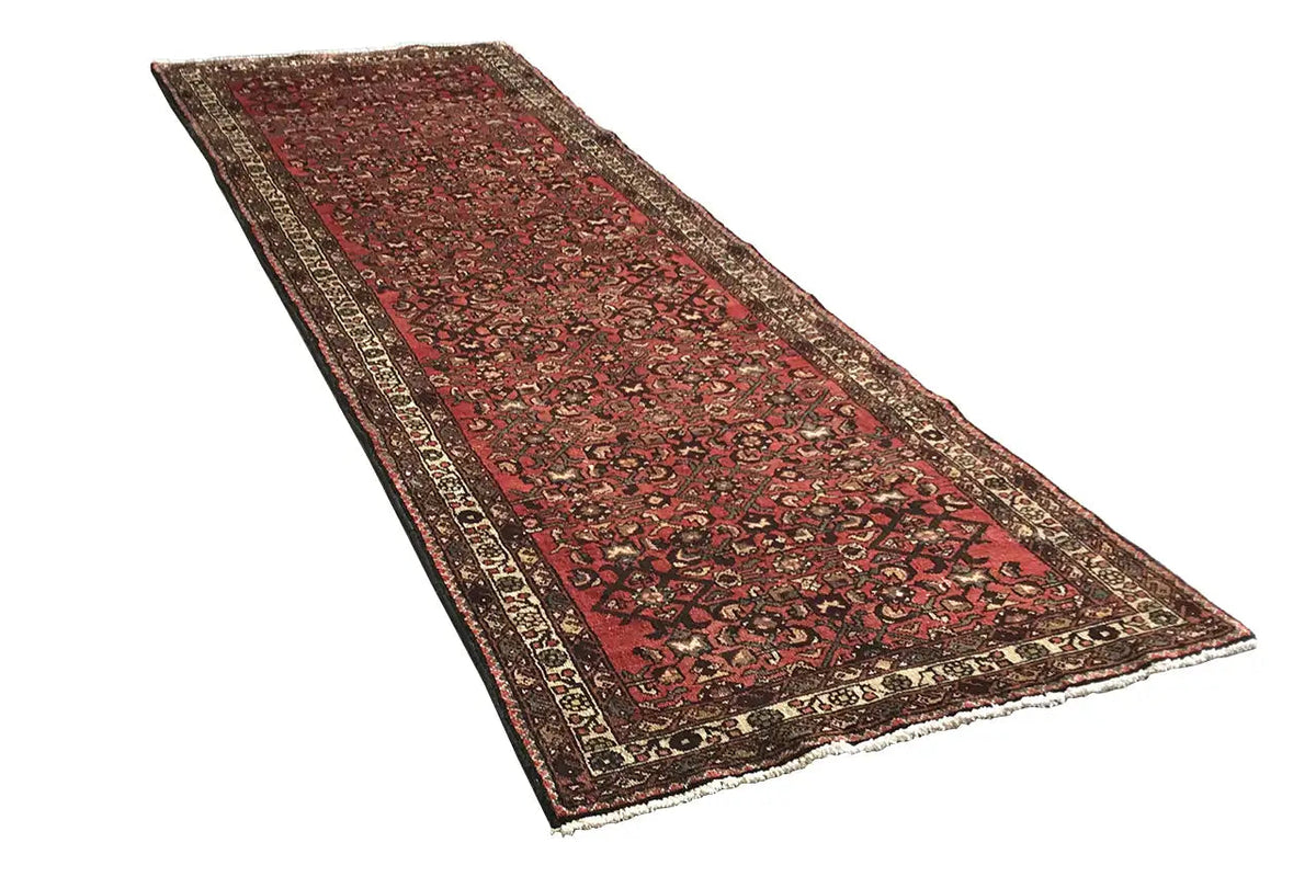 Rectangular runner rug, red with graphic ornaments and a dark border