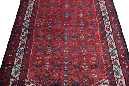 Close-up of the Oriental rug runner: red medallion pattern with blue-and-white border stripes
