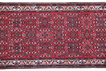 Red runner: uniform ornamental pattern with a decorative hem edge and trim stripes