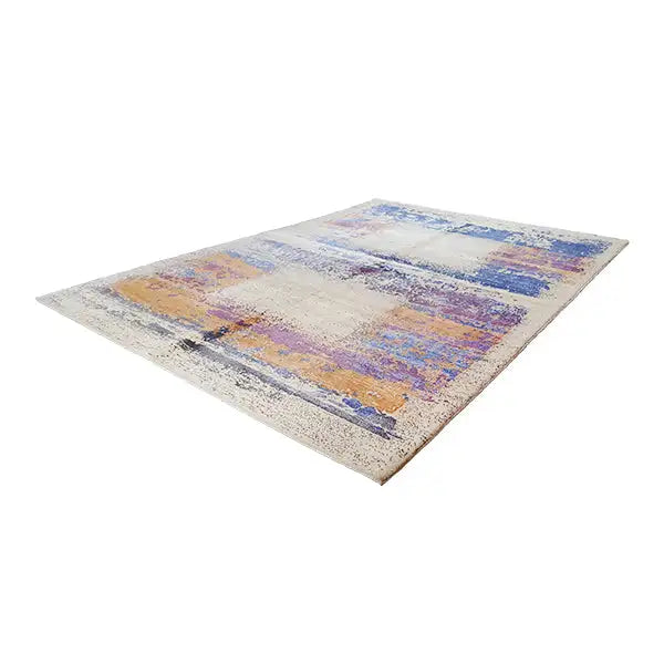 Designer rug laid flat; abstract shapes in blue, purple, and orange on beige