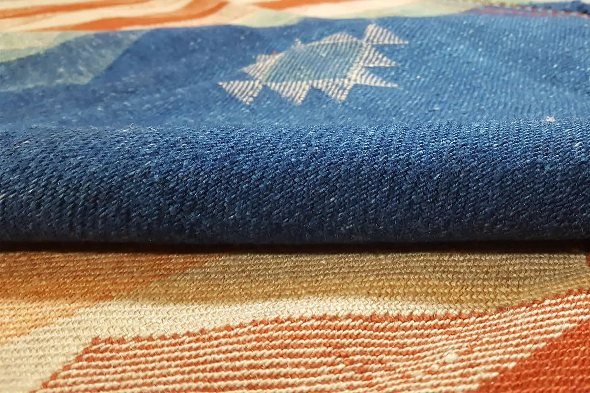 Jajim exclusive carpet fiber with a blue pattern, beige stripe, and orange accents