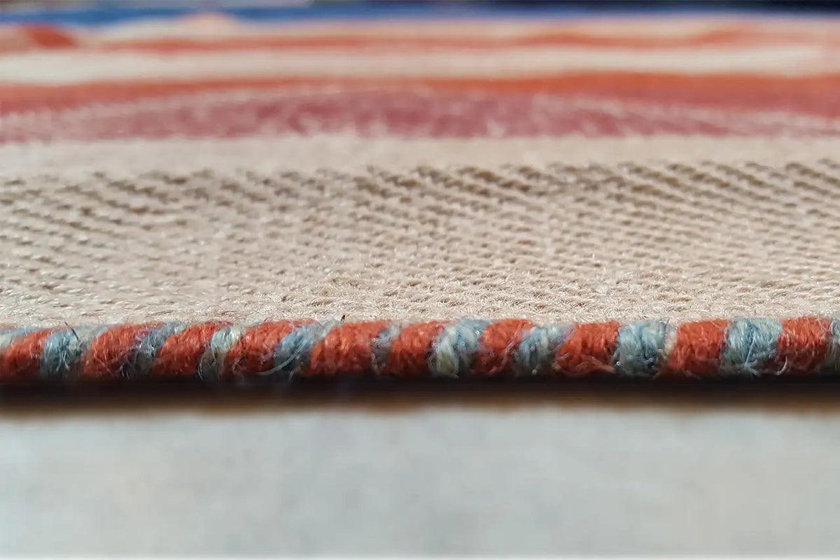 Jajim exclusive carpet edge with fringe made from blue, red, and beige yarn