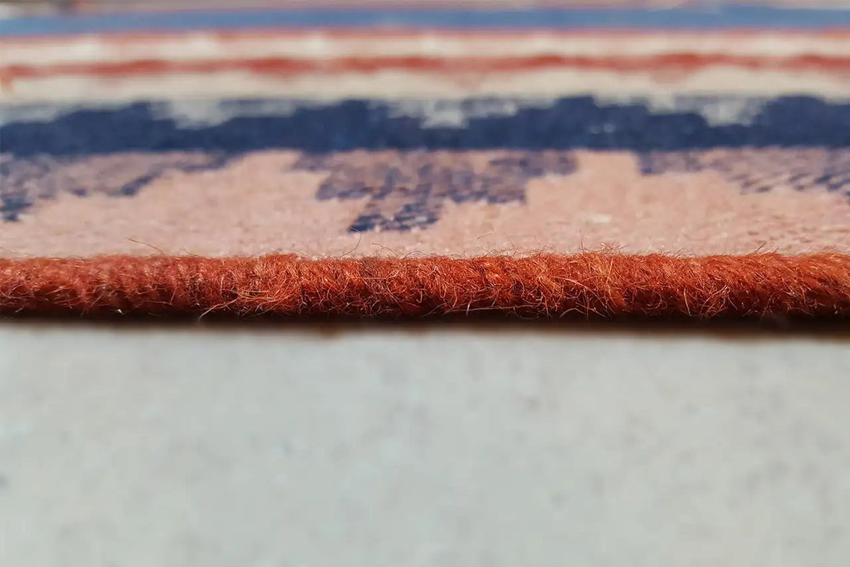 Close-up: Carpet edge with fringes and a multicolored woven pattern