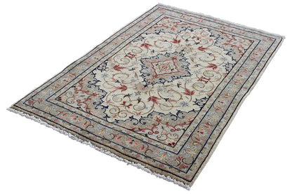 Beige Keshan rug with blue-red ornamental design, rectangular, fringed edge