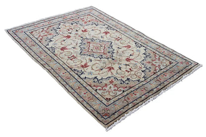 Beige Keshan rug with decorative border and floral Baroque motifs, laid diagonally