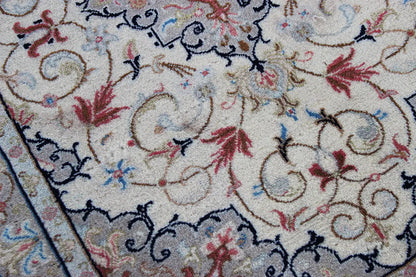 Keshan rug detail: beige pile with red flowers and blue linear ornaments