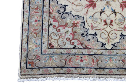 Keshan rug border detail with frame lines, a beige background, and red/blue accents