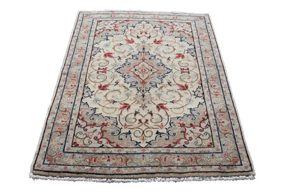 Beige Oriental rug with a blue border and red floral motifs, large-scale