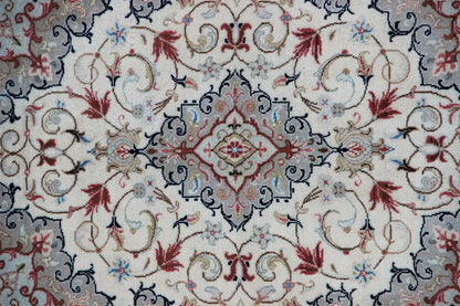 Close-up: beige carpet with a blue ornamental band and red flowers in the central motif