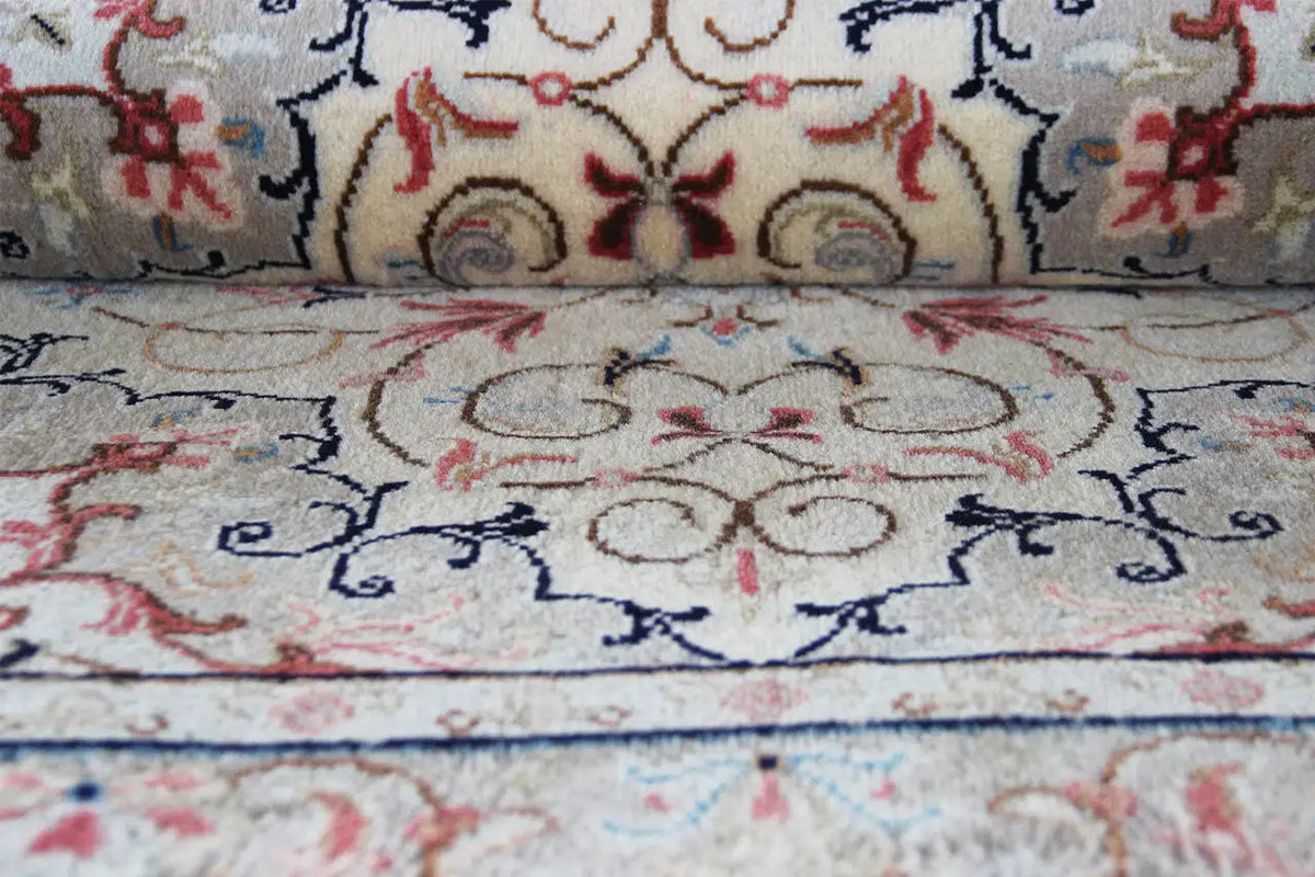 Close-up central motif: beige carpet with symmetrical floral ornament and blue linework