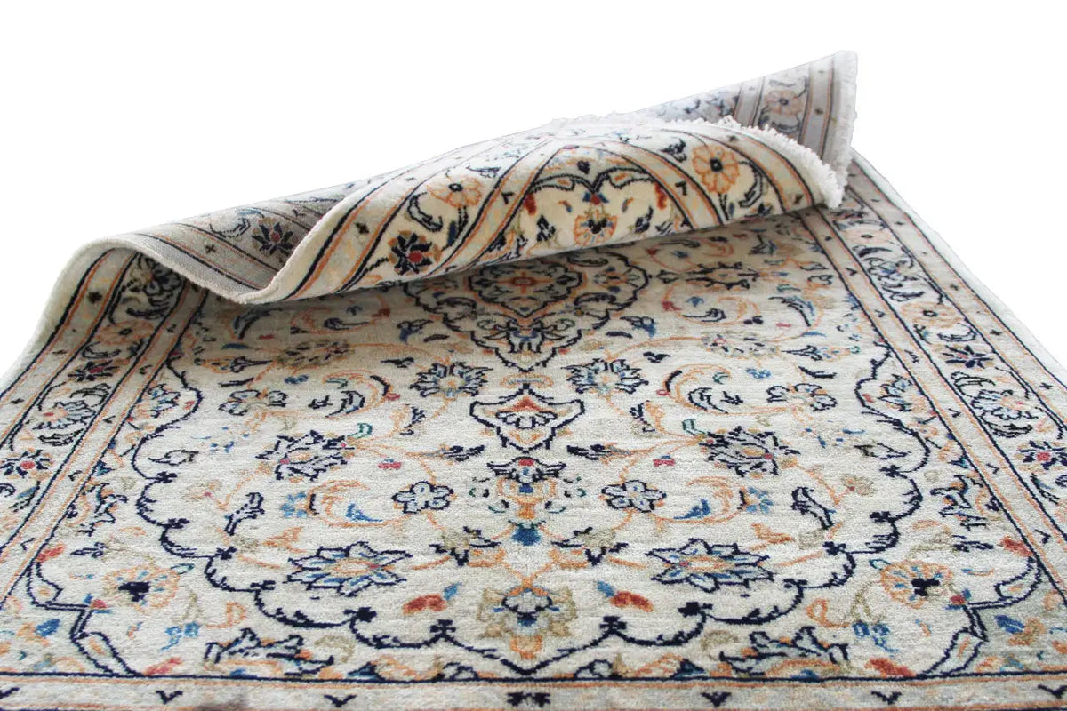Pieced-together Keshan rug with a beige pattern and border
