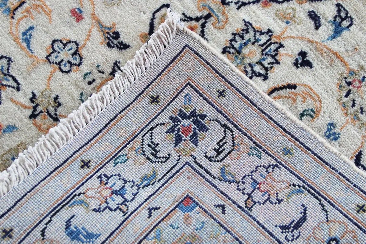 Corner detail: Keshan rug with a central medallion pattern in blue and red