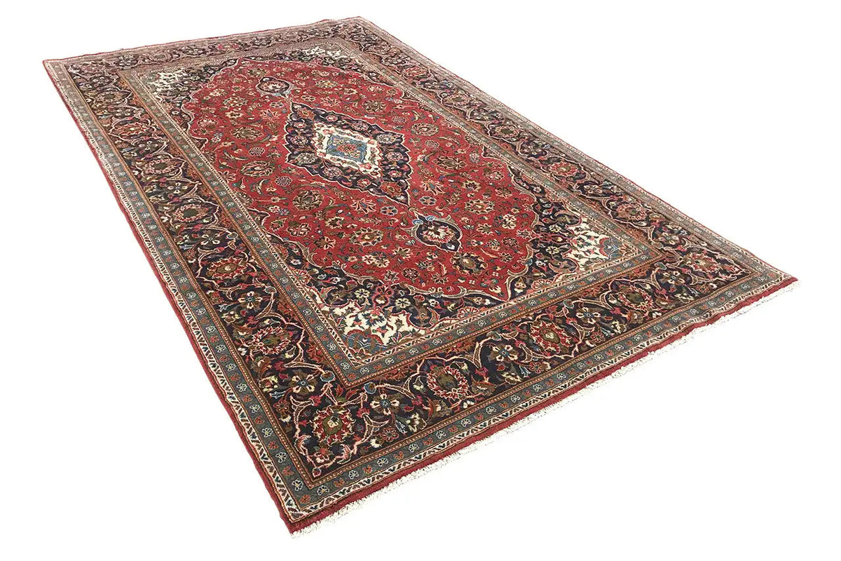 Red Oriental rug with a large medallion and decorative border