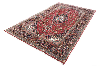 Oriental rug with a red ground, central medallion, and floral borders