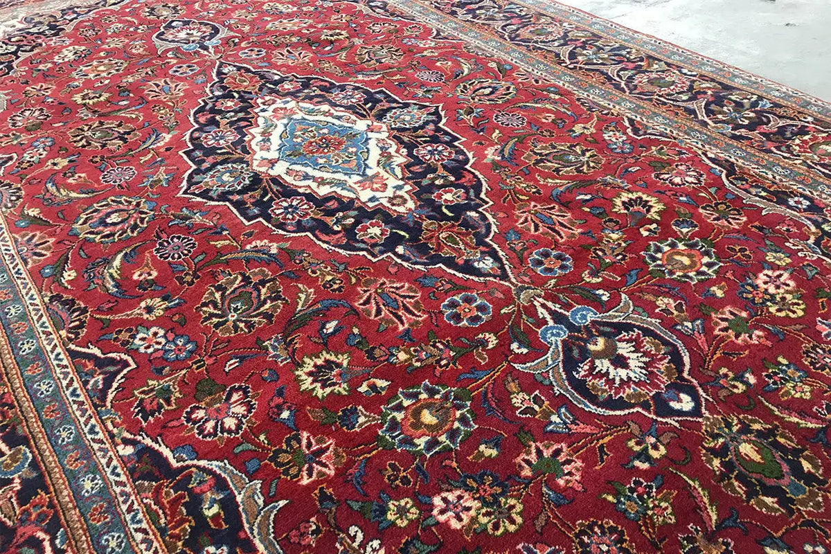 Close-up of an Oriental rug: red pattern, floral ornamentation, and ornate borders